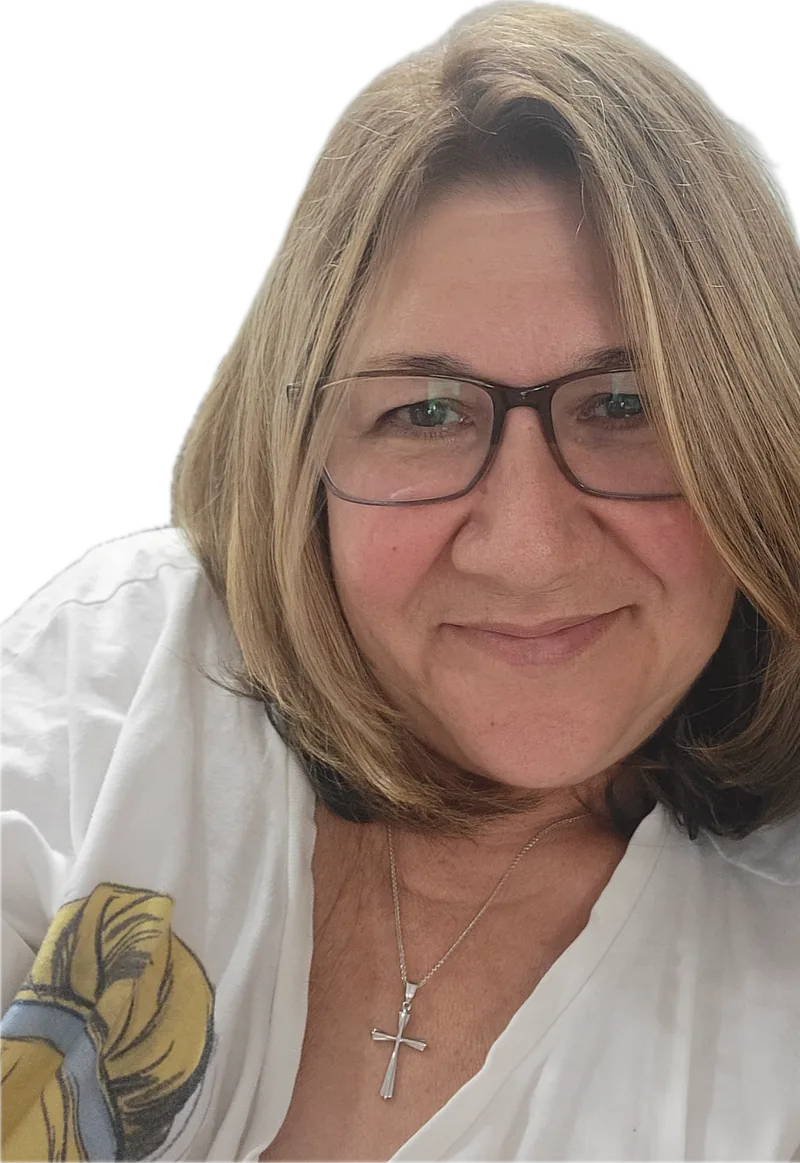 Gina Saporito, founder of Little Saporito Press, smiling and wearing green-rimmed glasses.